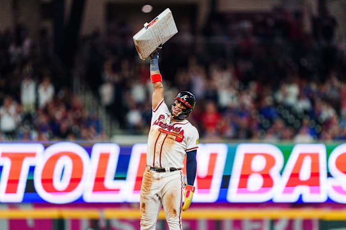 Atlanta Braves outfielder Ronald Acuña Jr celebrates after stealing his 70th base of the season in the 10th inning against the Chicago Cubs in Truist Park.